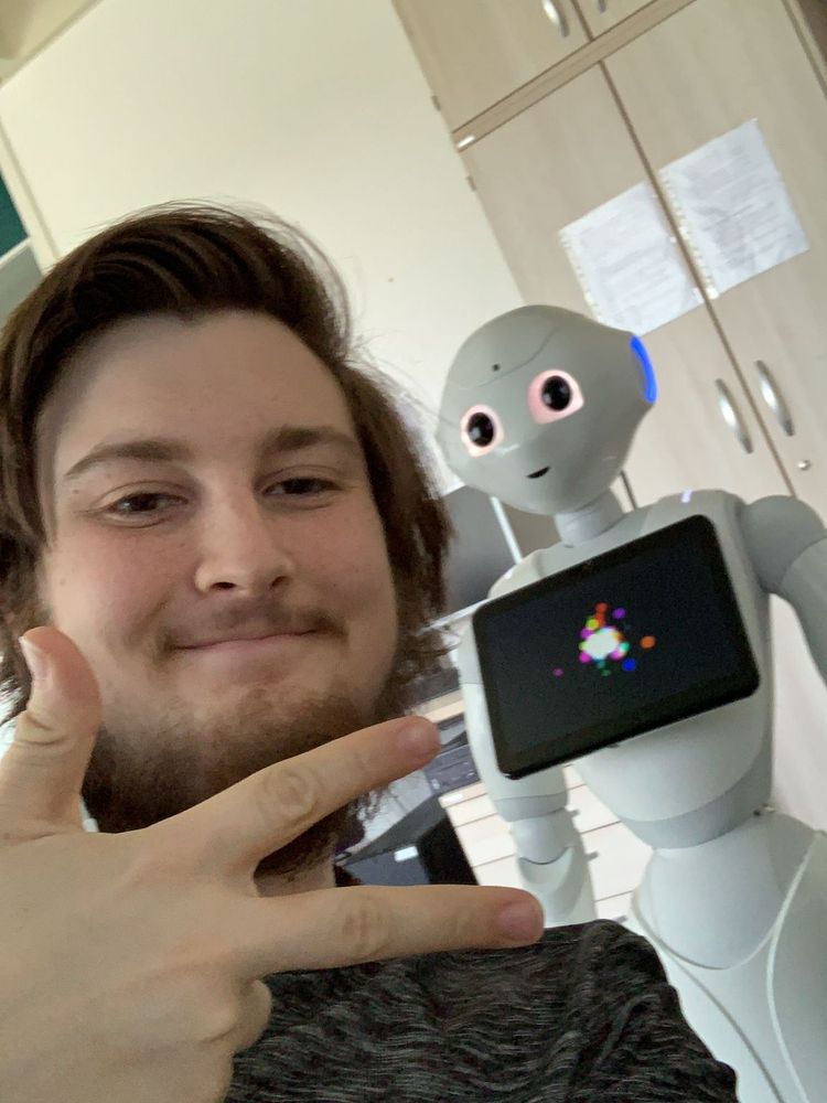 Me in front of the robot Pepper